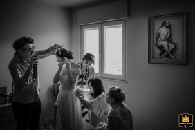 Foggia, Apulia, captures the high-pressure energy inside the bride's home as multiple vendors rush to finish their final preparations because the bride is running late.